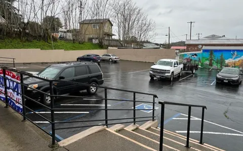 a view of a patio with a table chairs and a barbeque