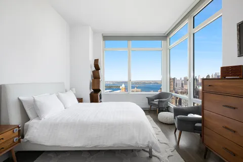 a bedroom with bed and balcony
