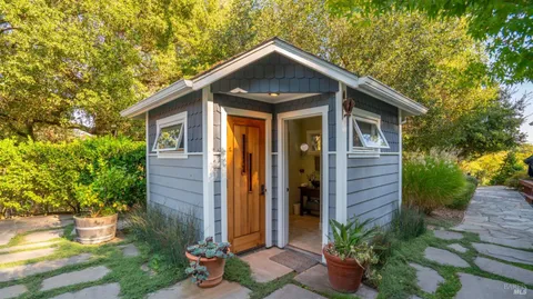 a front view of a house with garden