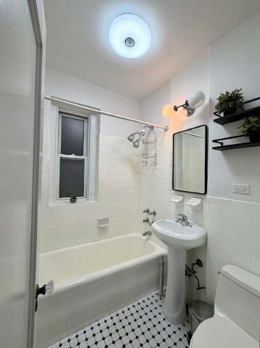 223 East 50th Street, Unit 1C Manhattan, NY 10022 - Photo 10 of 10 a bathroom with a sink toilet and shower