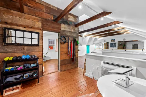 a living room with furniture a rug and a floor to ceiling window