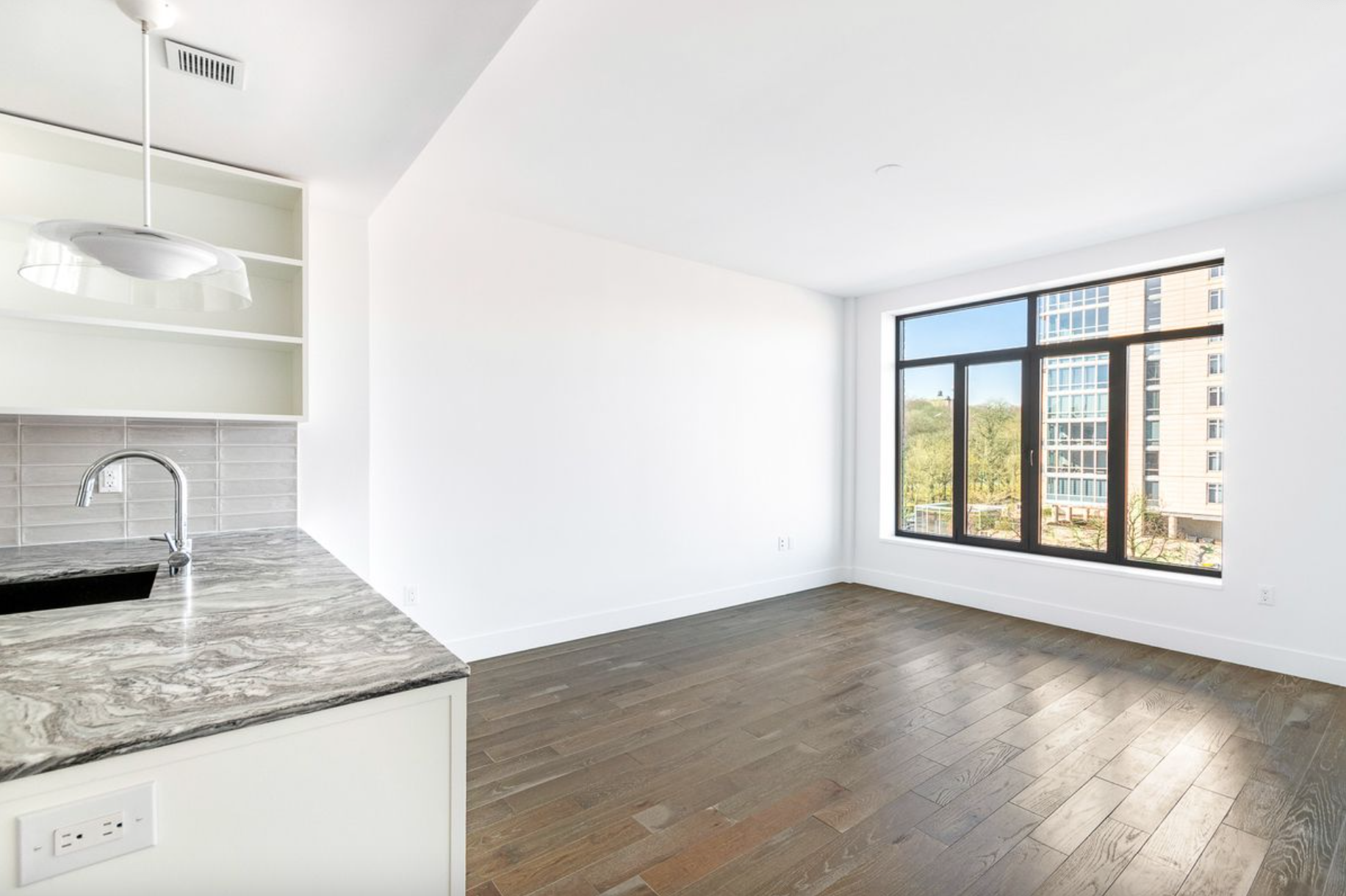 10 Lenox Avenue, Unit 5D Manhattan, NY 10026 - Photo 3 of 13 a view of a kitchen with granite countertop cabinets and window