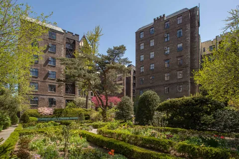 a view of a pathway of a building with potted plants