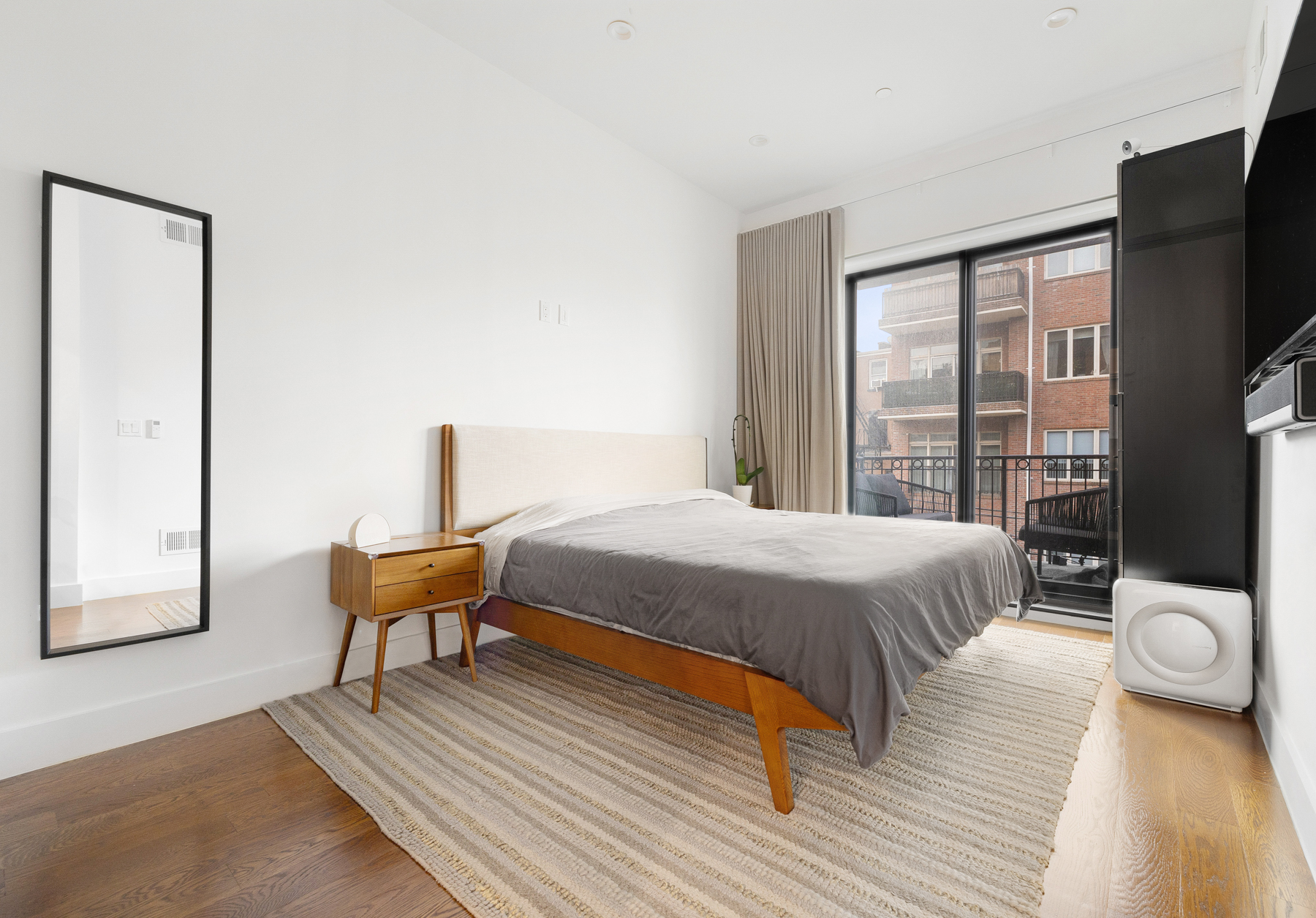 110 Summit Street, Unit 2 Brooklyn, NY 11231 - Photo 6 of 13 a bedroom with a bed and a flat screen tv