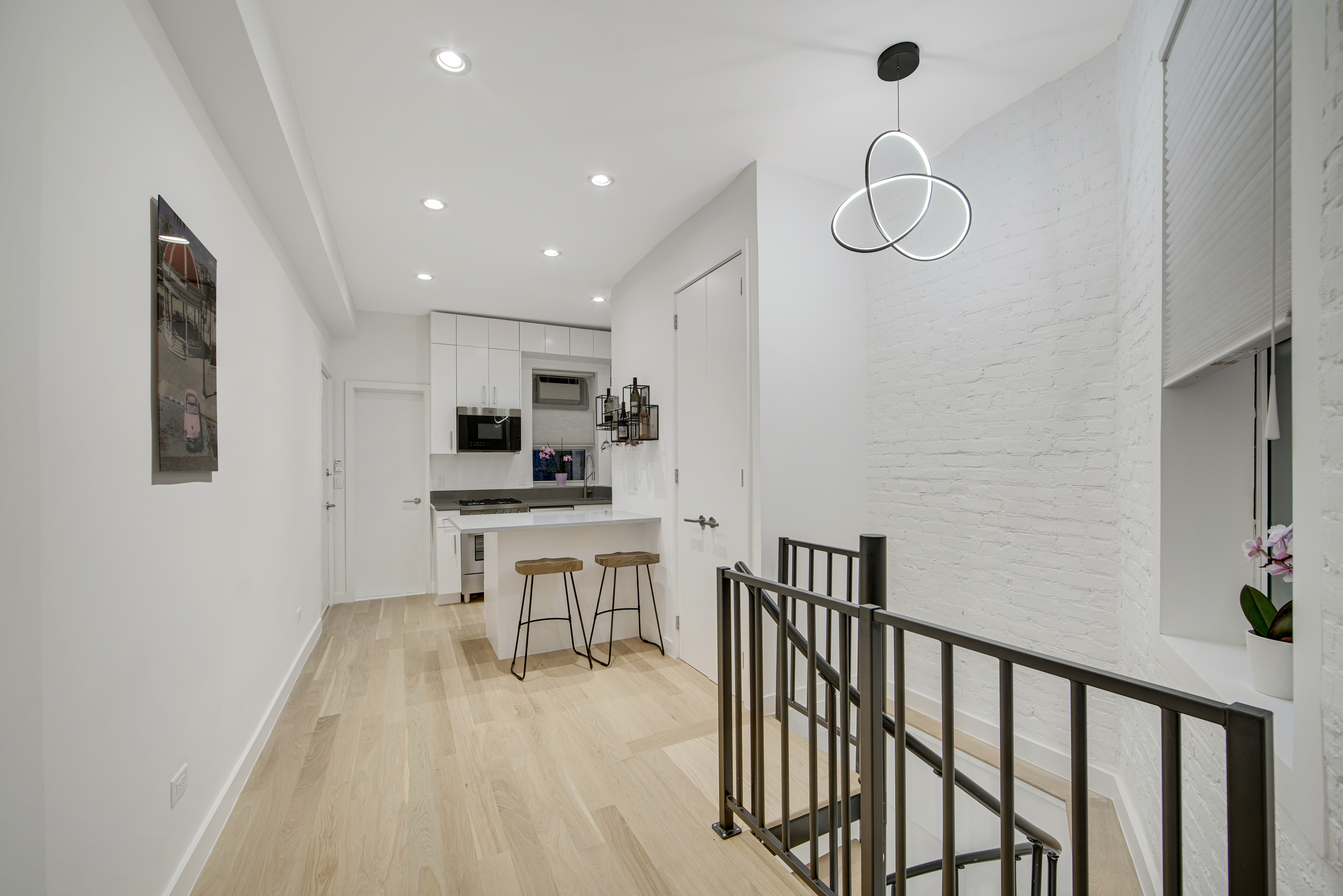 a view of a room with chairs and wooden floor