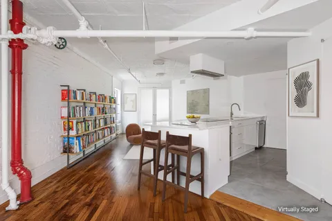 a kitchen with a dining table chairs and refrigerator