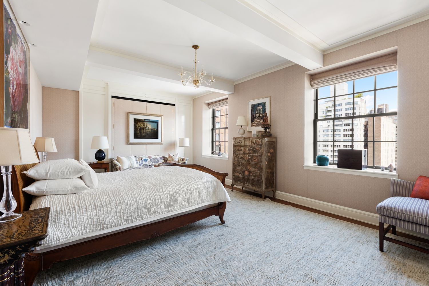 a spacious bedroom with a bed couch and a window