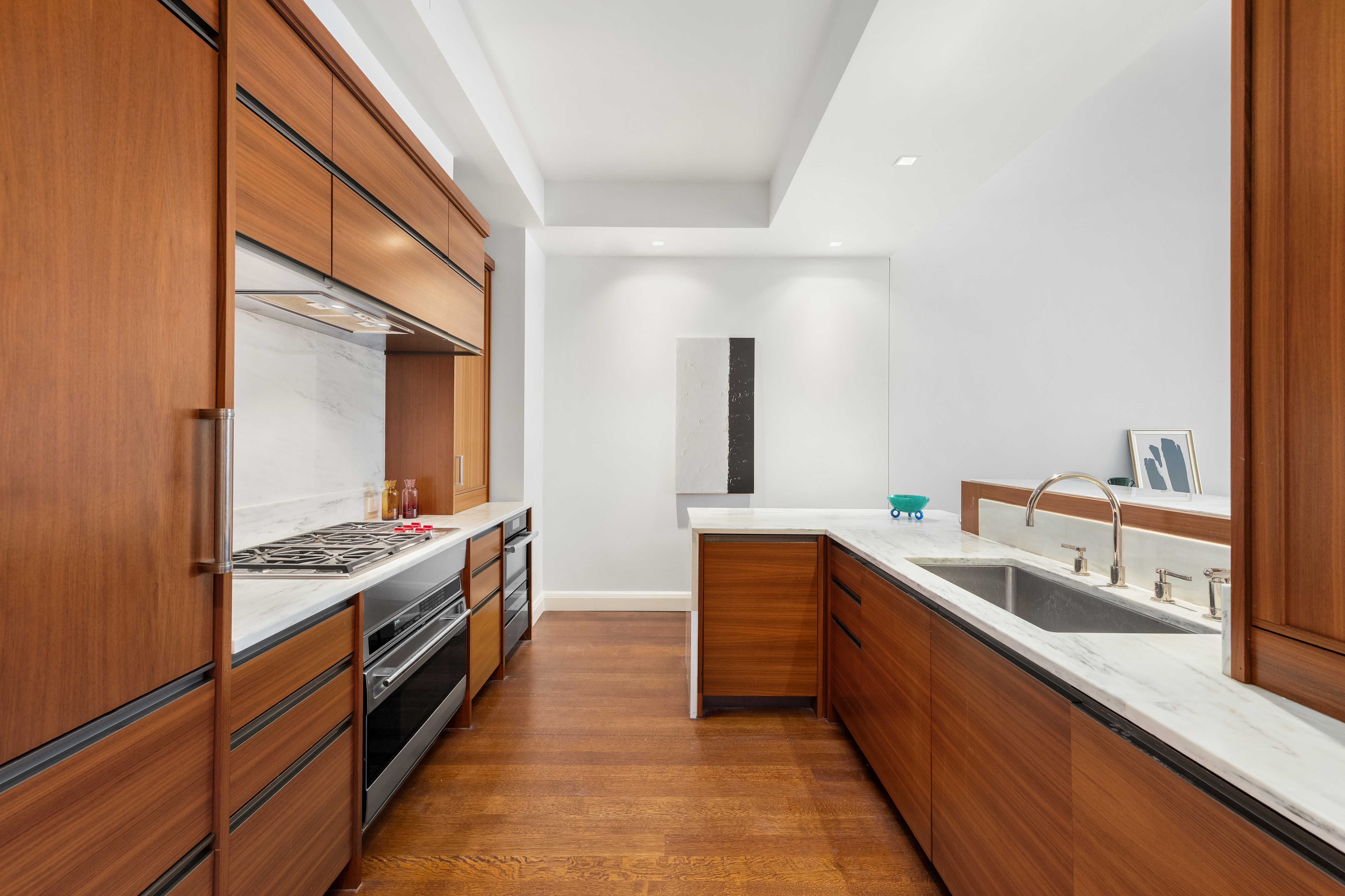 150 Charles Street, Unit 4AN Manhattan, NY 10014 - Photo 4 of 19 a kitchen with stainless steel appliances granite countertop a sink and a stove