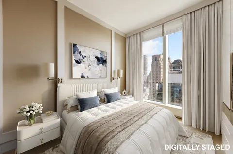 a bedroom with a large bed and a painting on the wall