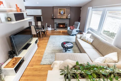 a living room with furniture fireplace and rug
