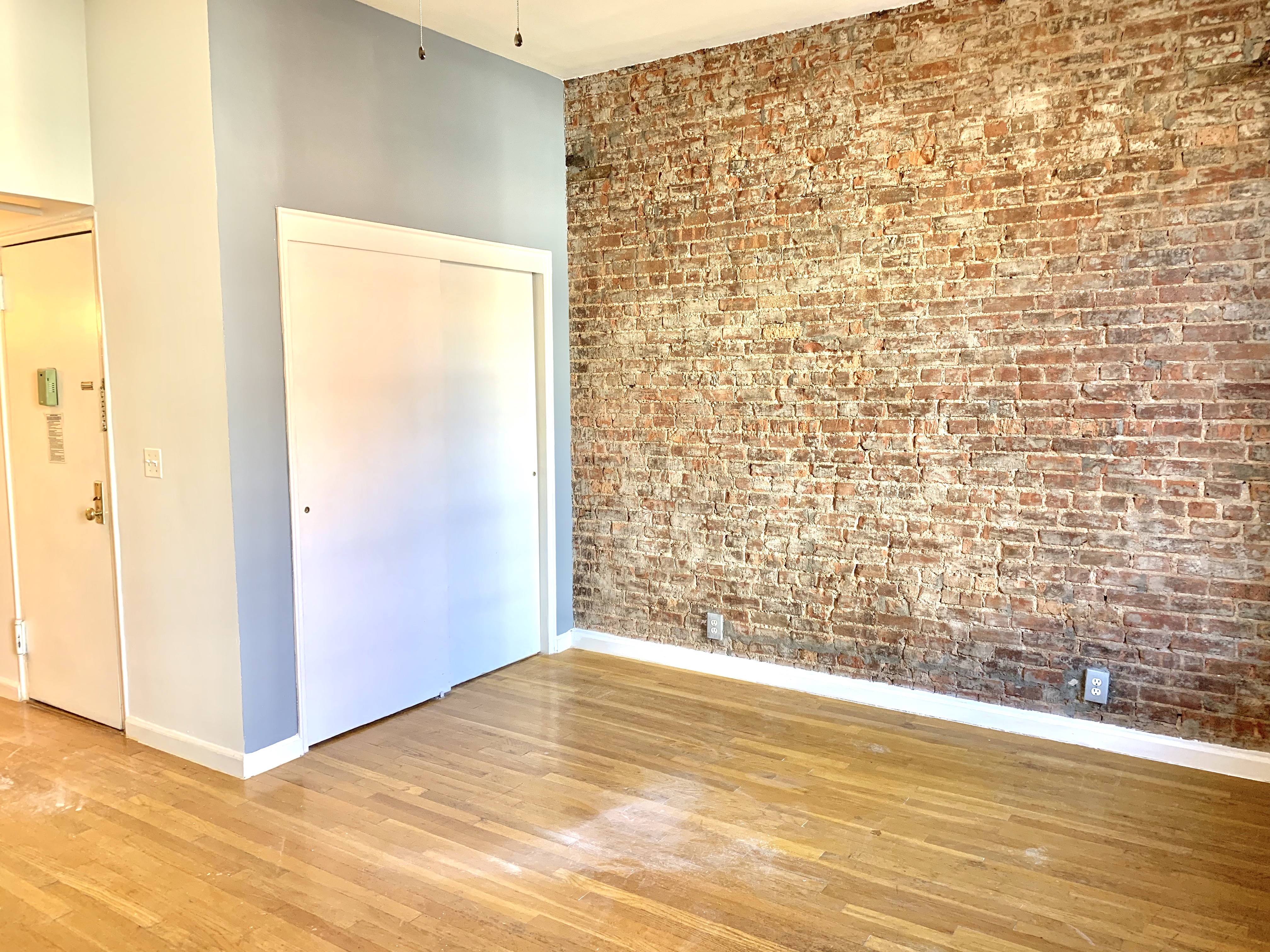 116 West 131st Street, Unit 7 Manhattan, NY 10027 - Photo 2 of 5 a view of empty room with wooden floor