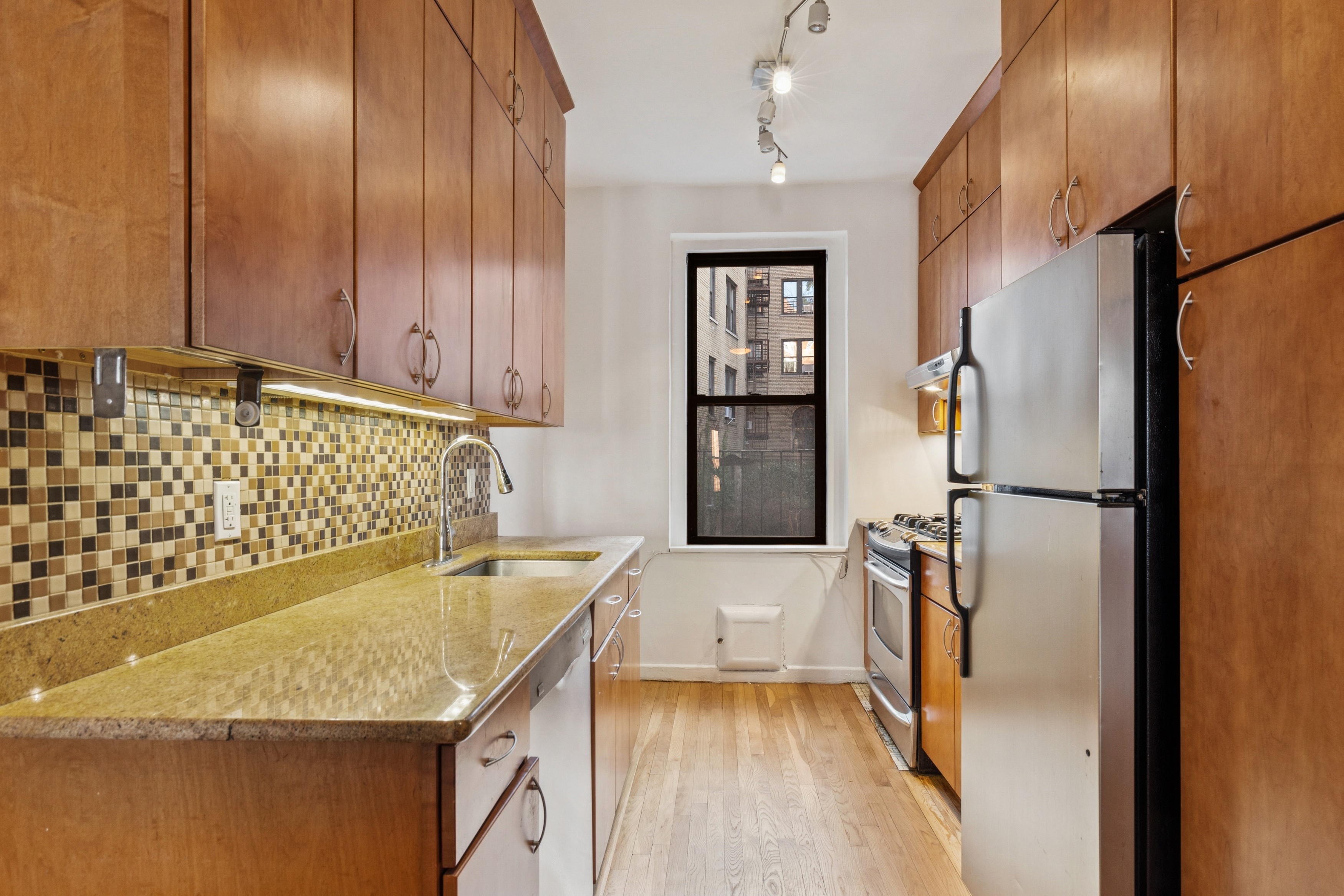 115 Cabrini Boulevard, Unit B51 Manhattan, NY 10033 - Photo 8 of 23 a kitchen with stainless steel appliances granite countertop a refrigerator and a sink