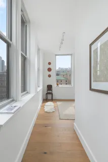 a bathroom with sink a bathtub and next to a window