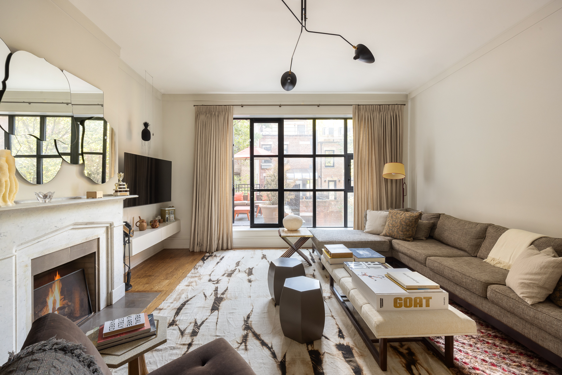 22 West 70th Street Manhattan, NY 10023 - Photo 8 of 12 a living room with furniture a flat screen tv and a fireplace
