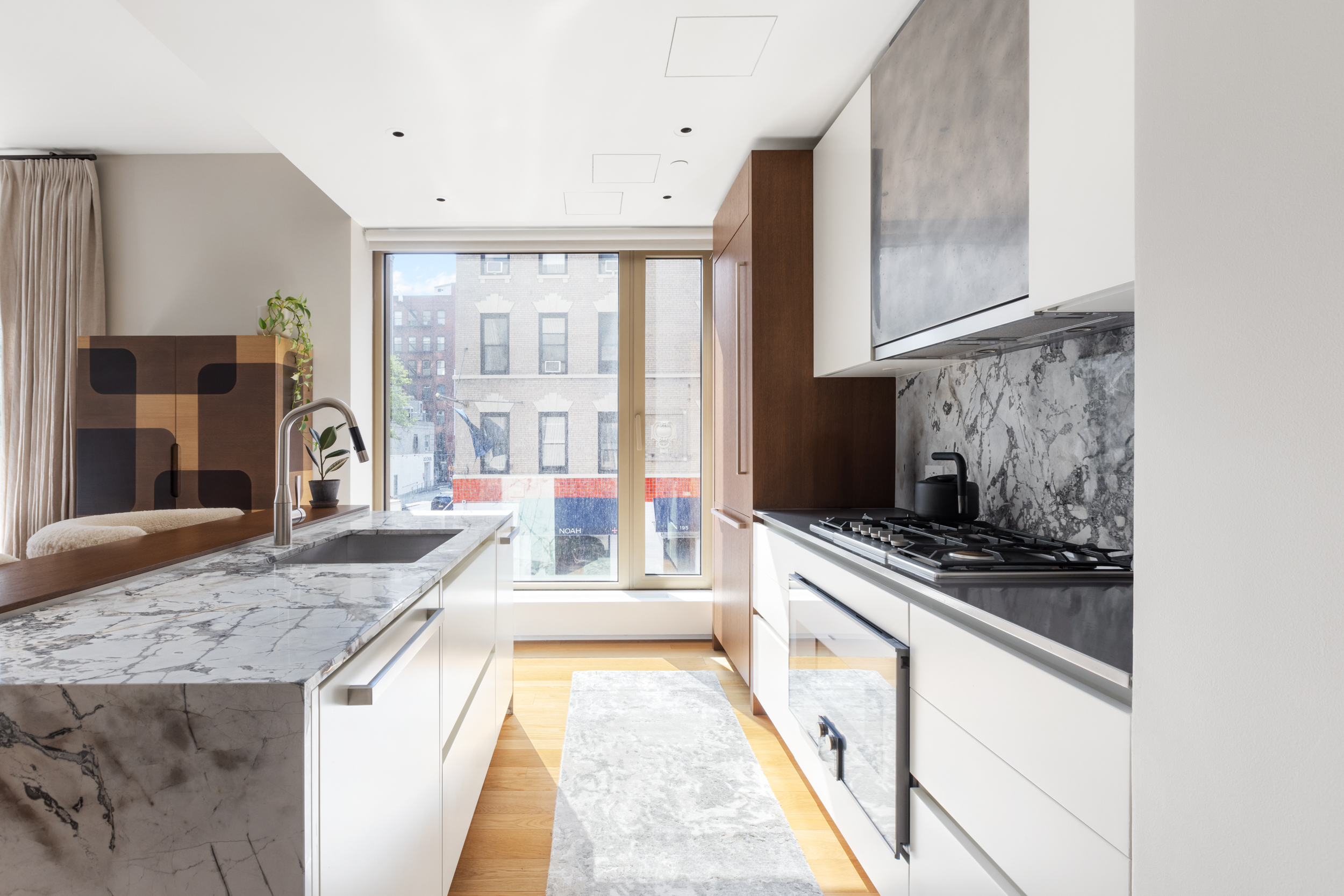 75 Kenmare Street, Unit 2D Manhattan, NY 10012 - Photo 5 of 15 a large kitchen with a stove and a sink