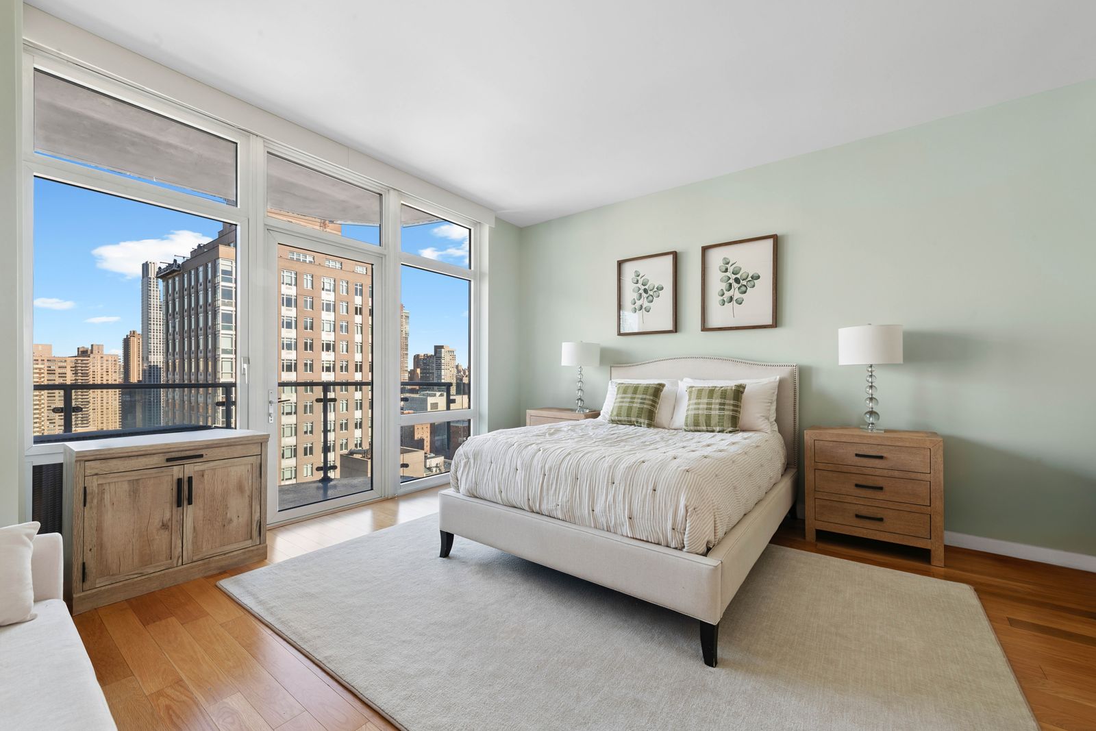 555 West 59th Street, Unit 25E Manhattan, NY 10019 - Photo 5 of 18 a spacious bedroom with a bed and glass door
