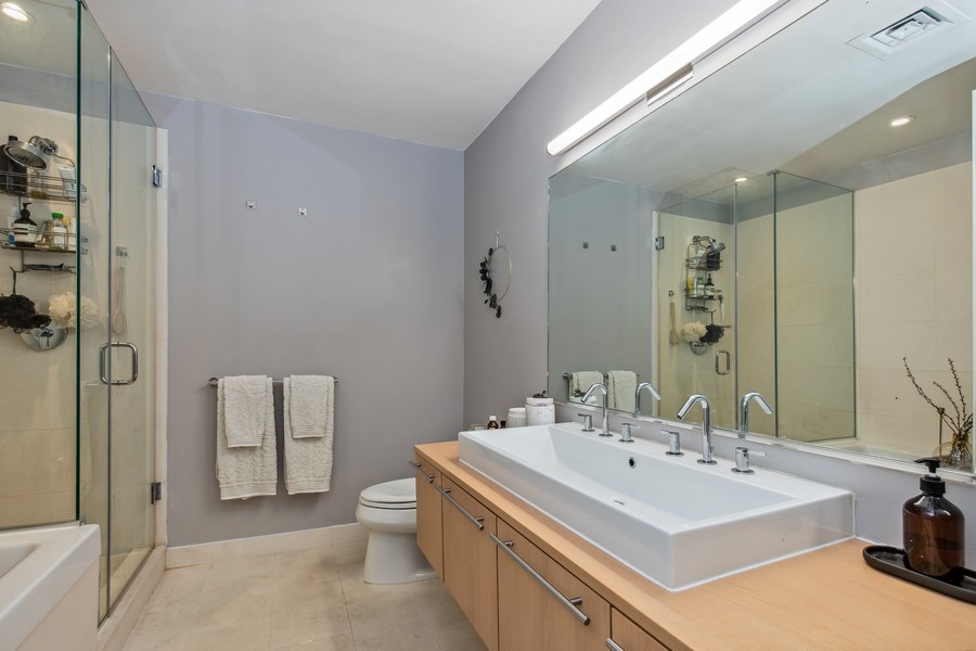 119 Fulton Street, Unit 2B Manhattan, NY 10038 - Photo 8 of 10 a bathroom with a sink a toilet and shower