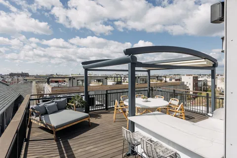 an outdoor living space with patio furniture