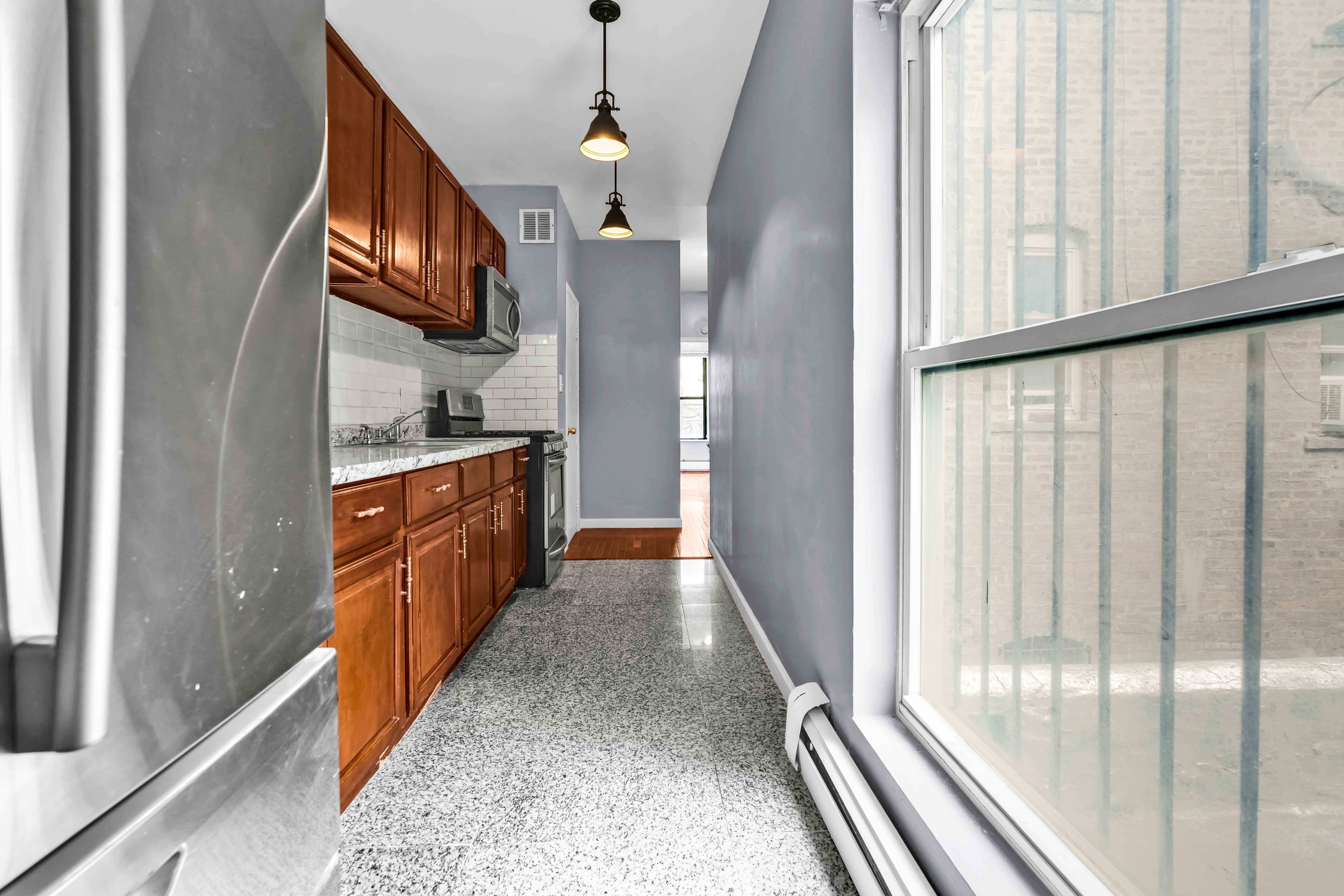 1633 St Johns Place, Unit 3 Brooklyn, NY 11233 - Photo 23 of 29 a view of a hallway with wooden floor and staircase