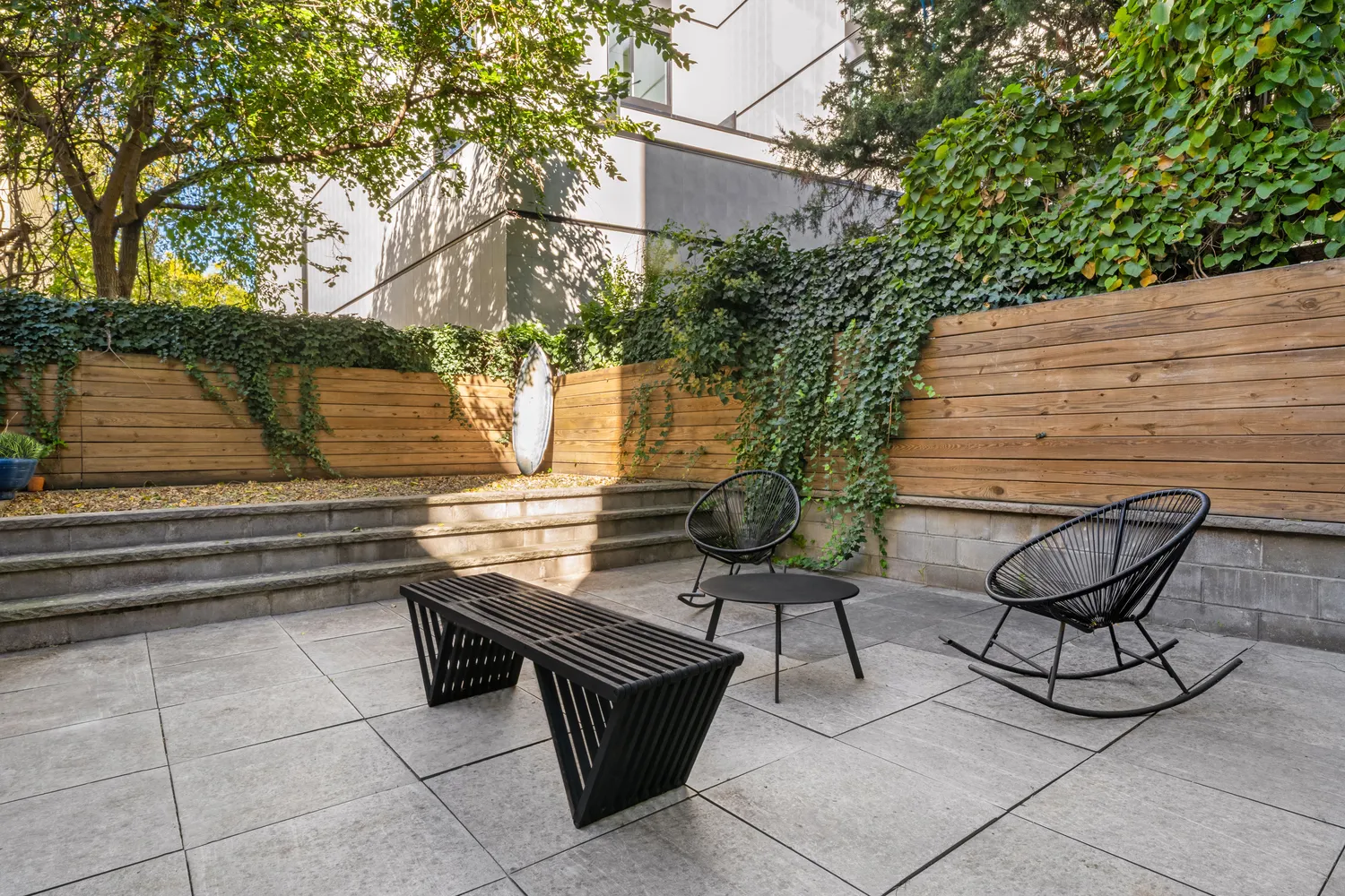 a backyard of a house with table and chairs