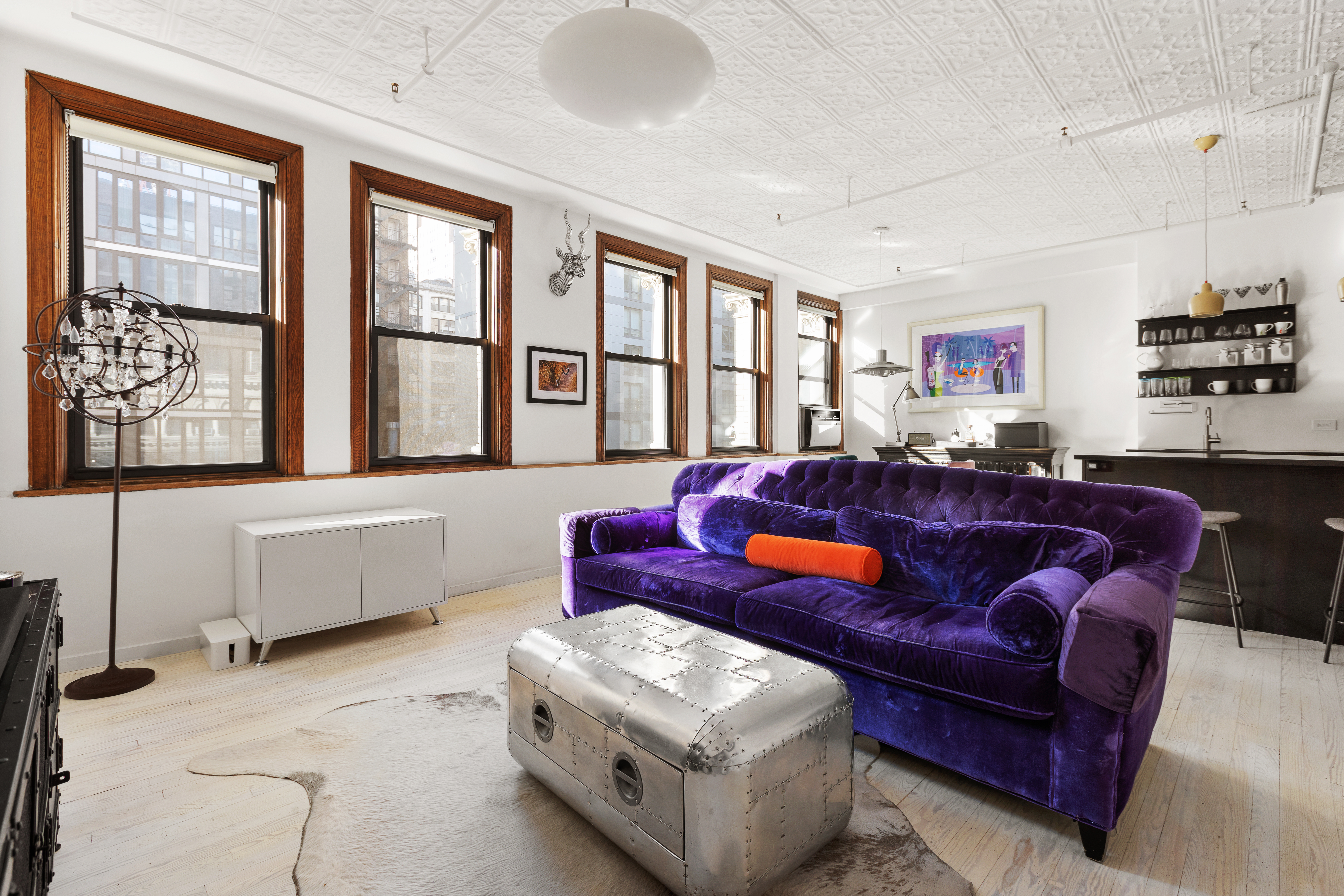 133-131 West 28th Street, Unit 7A Manhattan, NY 10001 - Photo 1 of 11 a living room with furniture and a window