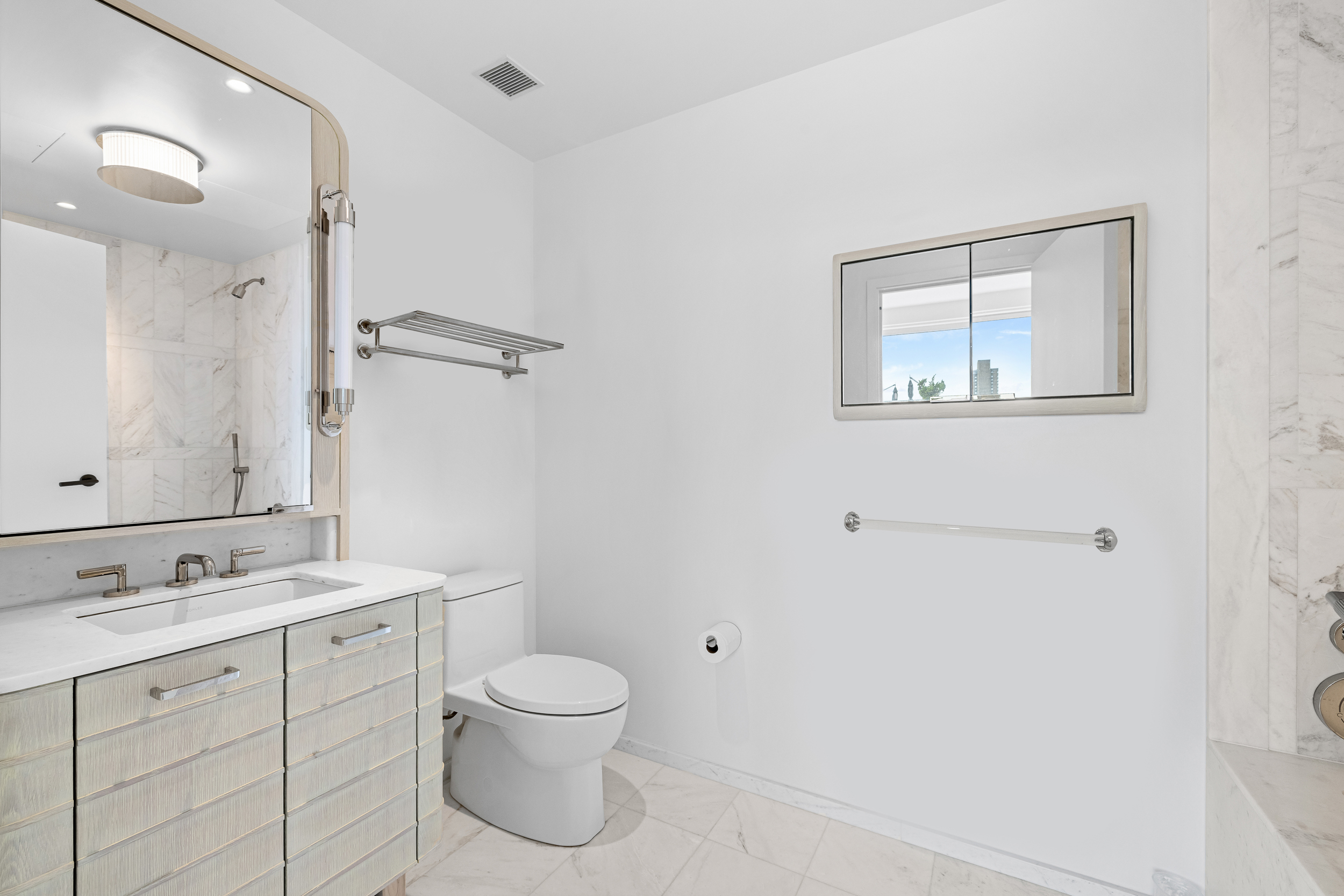 249 East 62nd Street, Unit 10B Manhattan, NY 10065 - Photo 6 of 21 a bathroom with a toilet sink and mirror