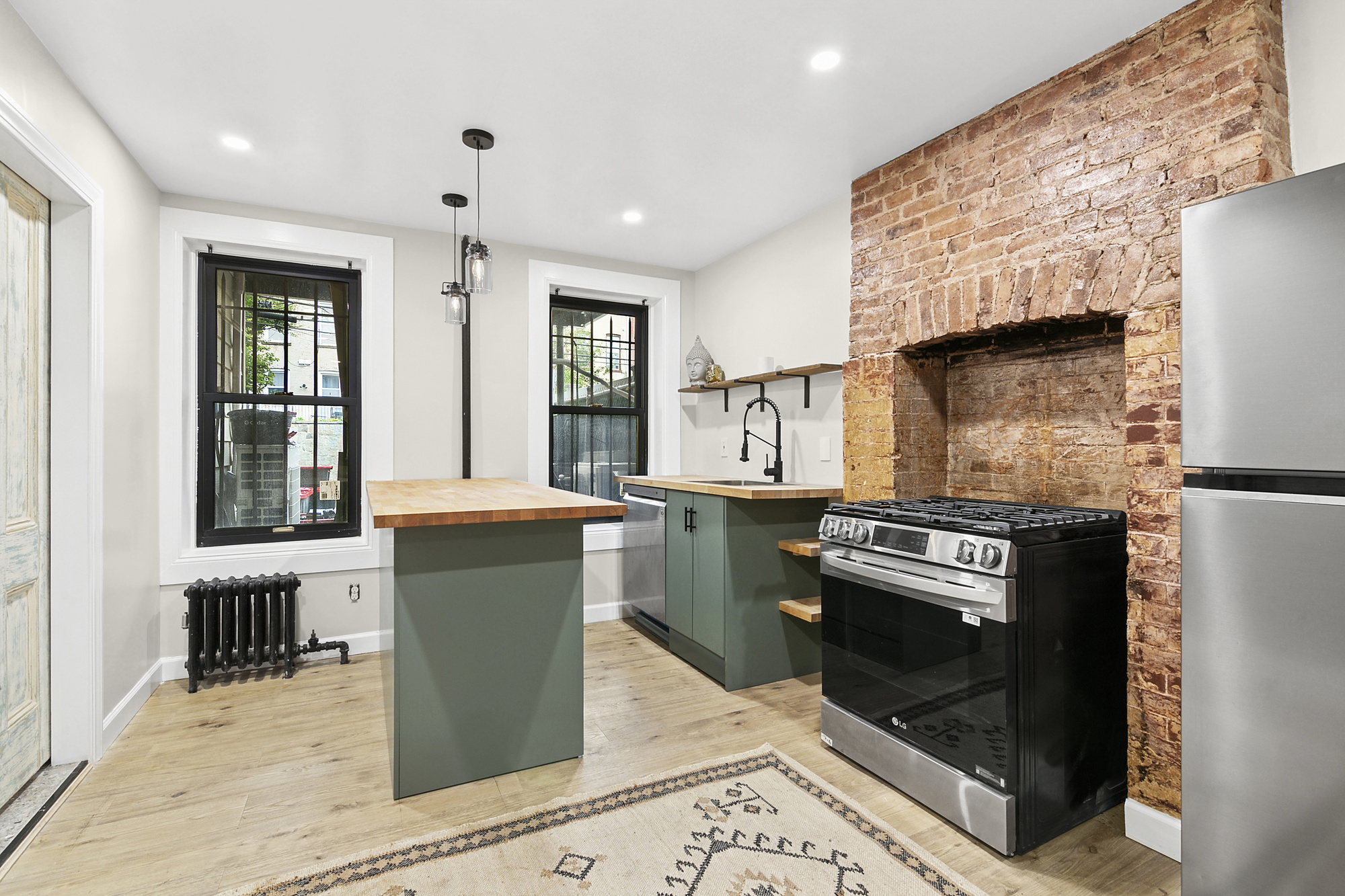 a kitchen with a refrigerator and a stove