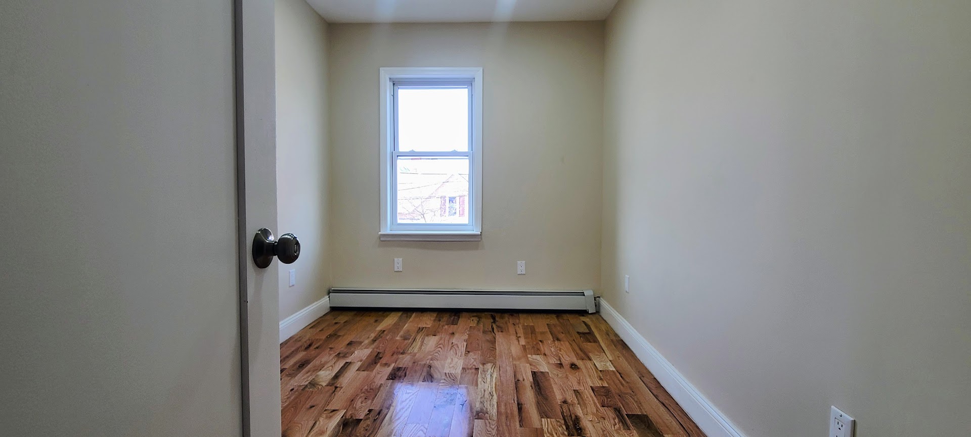 97-08 Plattwood Avenue, Unit 2 Queens, NY 11417 - Photo 7 of 10 an empty room with window