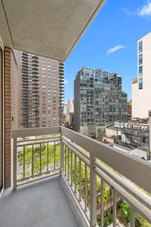 a bedroom with a bed and dresser with mirror