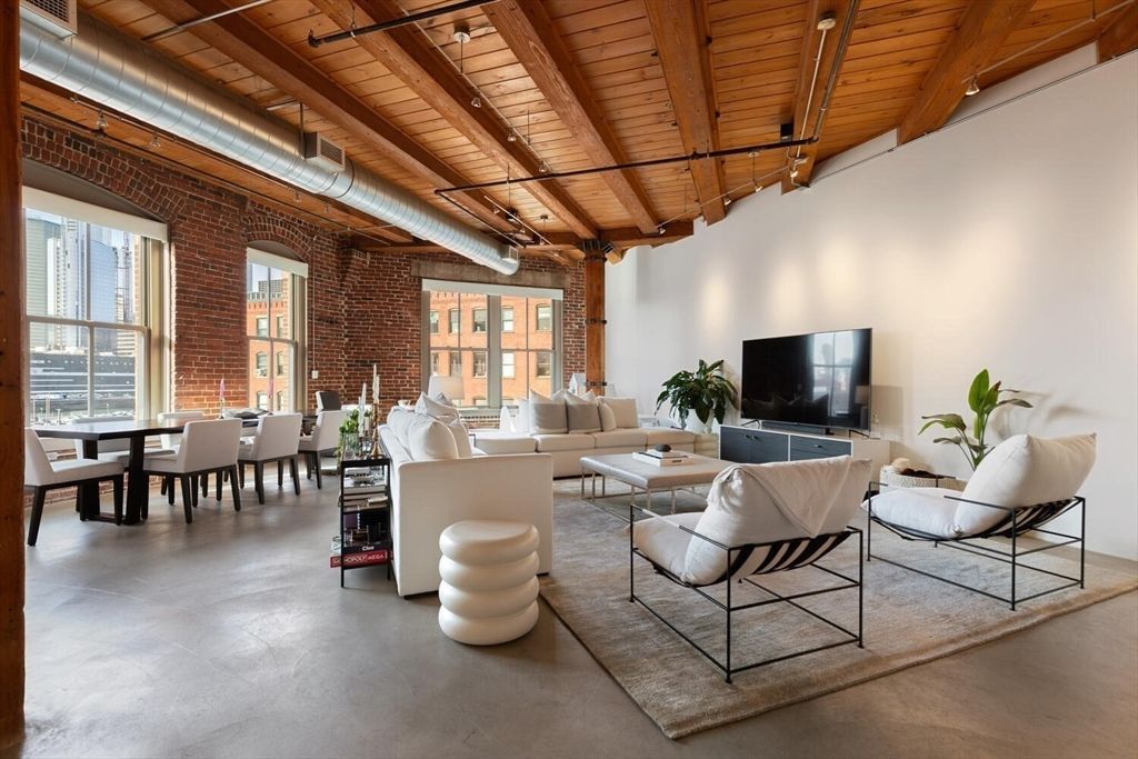 a living room with lots of furniture and a flat screen tv
