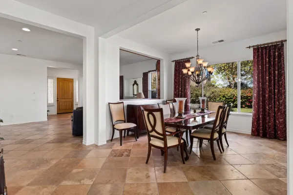 a view of a dining room with furniture and a chandelier