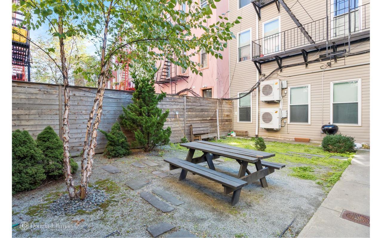251 Powers Street Brooklyn, NY 11211 - Photo 10 of 11 a view of a bench in a patio