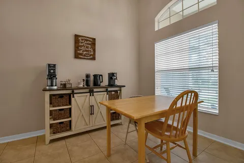 a living room with furniture ceiling fan and a window