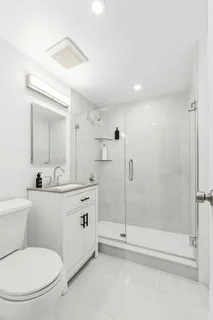 a bathroom with a toilet sink and shower
