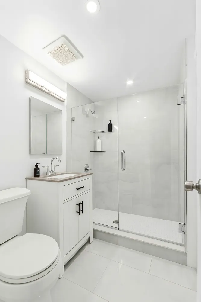 a bathroom with a toilet sink and shower