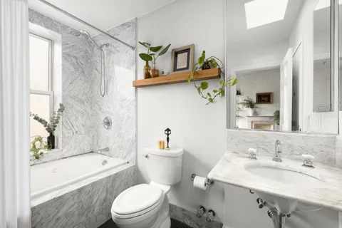 a bathroom with a sink a toilet and bathtub