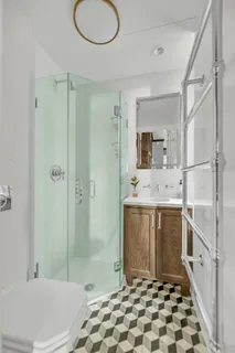 a bathroom with a sink a toilet and shower