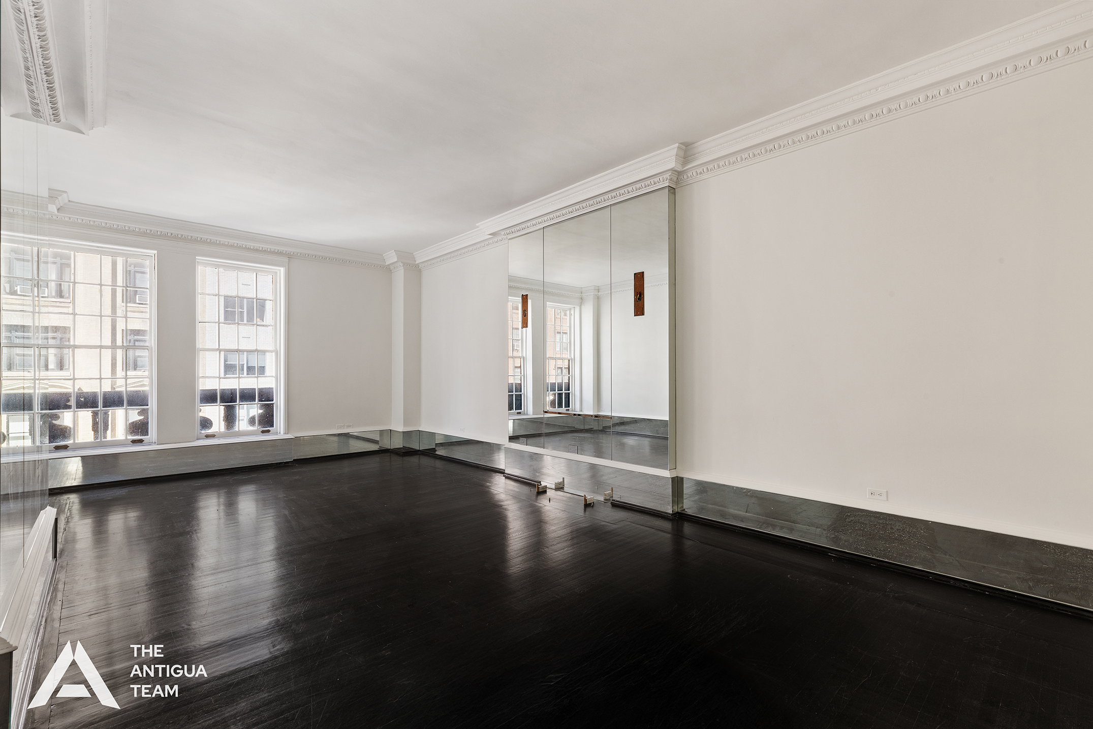 45 East 66th Street, Unit 4W Manhattan, NY 10065 - Photo 7 of 27 a view of an empty room with wooden floor and a window