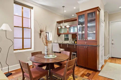 a view of a dining room with furniture and a chandelier