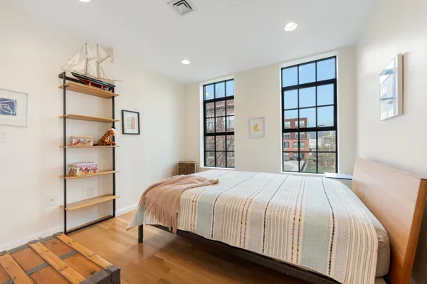 a bedroom with a large bed and a window