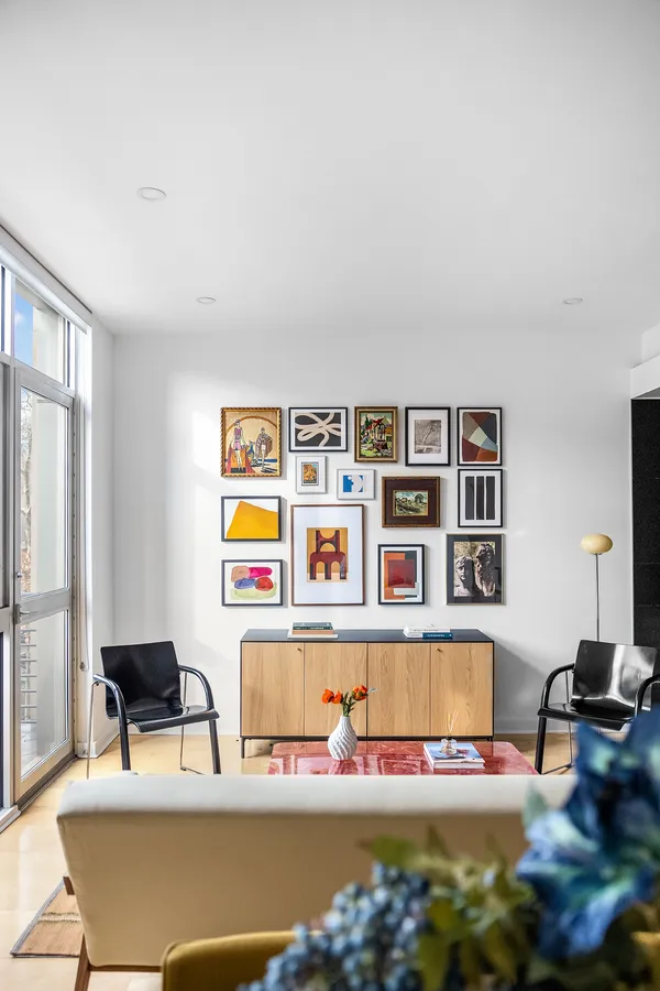 a living room with furniture and a book shelf