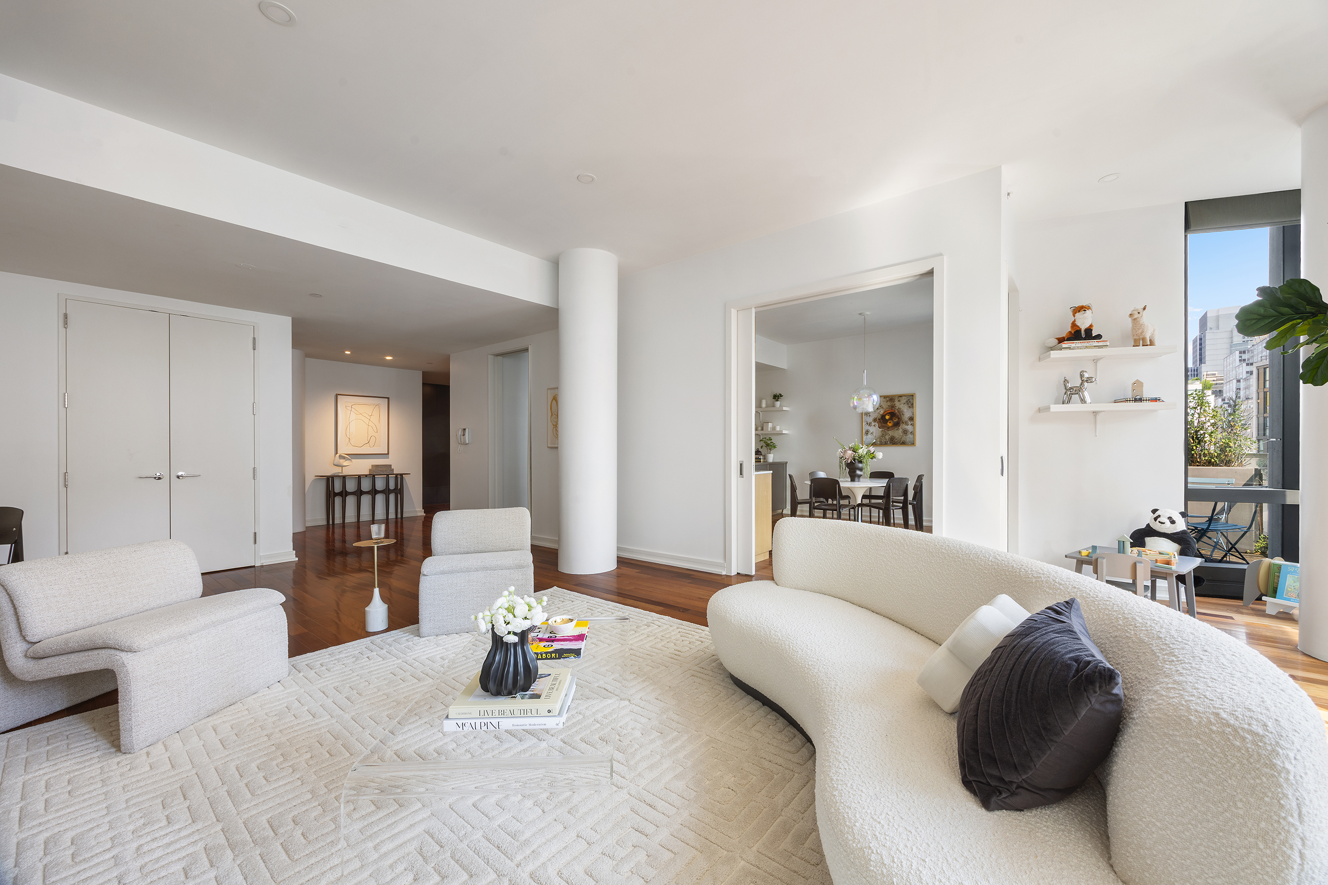 101 Warren Street, Unit 11L Manhattan, NY 10007 - Photo 7 of 28 a living room with furniture and a wooden floor