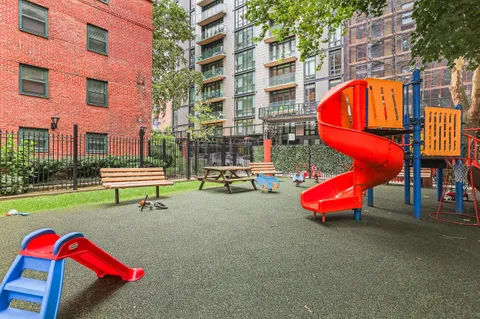 a bench is sitting in front of brick building