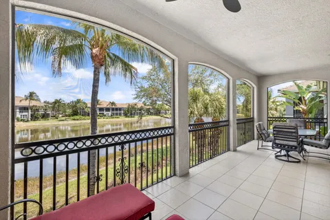 a balcony with furniture and a potted plant
