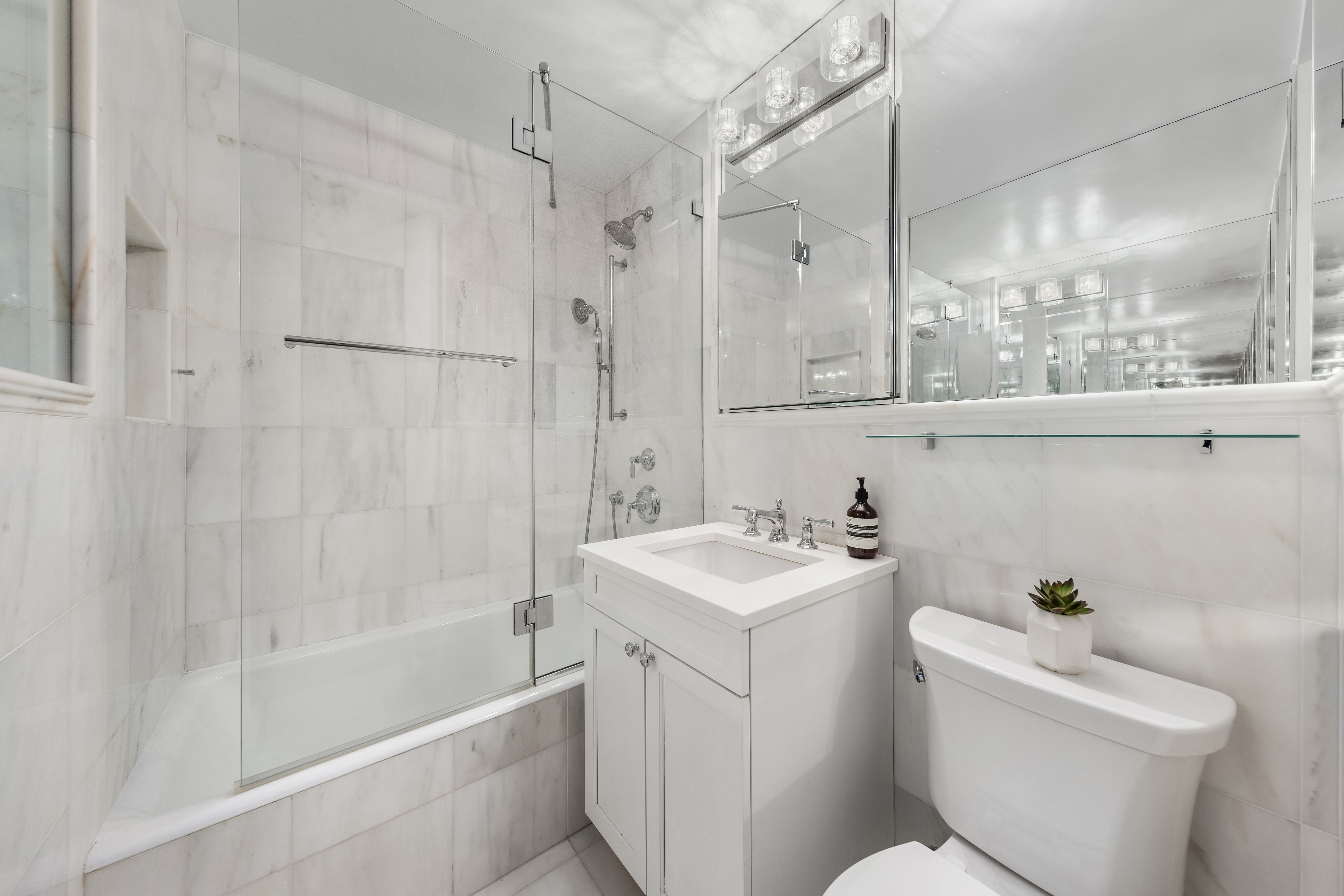305 East 40th Street, Unit 5K Manhattan, NY 10016 - Photo 9 of 15 a bathroom with a sink a toilet and shower