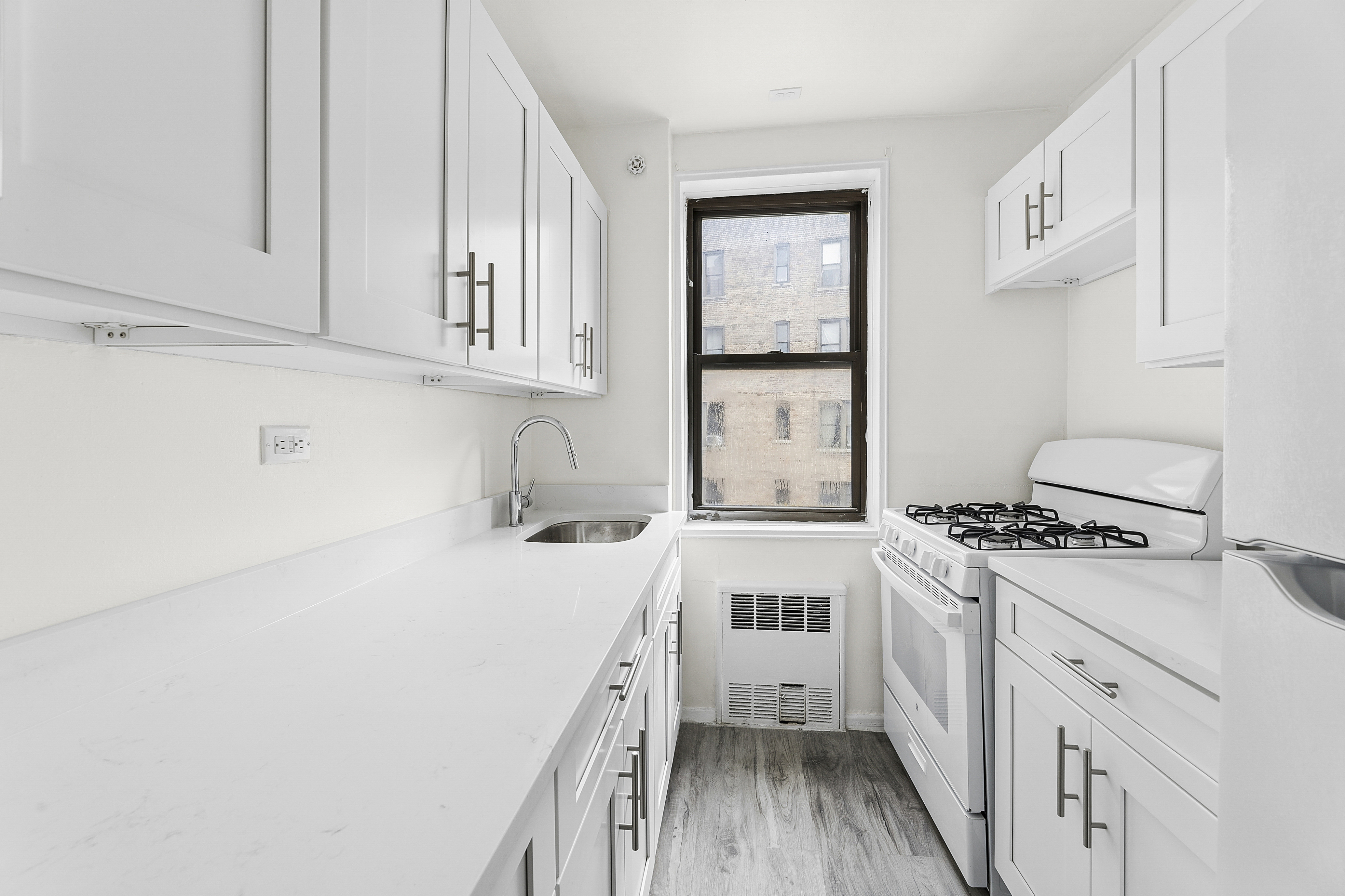 6645 Broadway, Unit 7E Bronx, NY 10471 - Photo 7 of 11 a kitchen with a stove a sink and a refrigerator