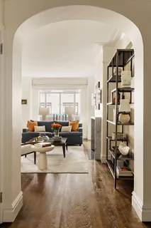 a living room with furniture and a floor to ceiling window