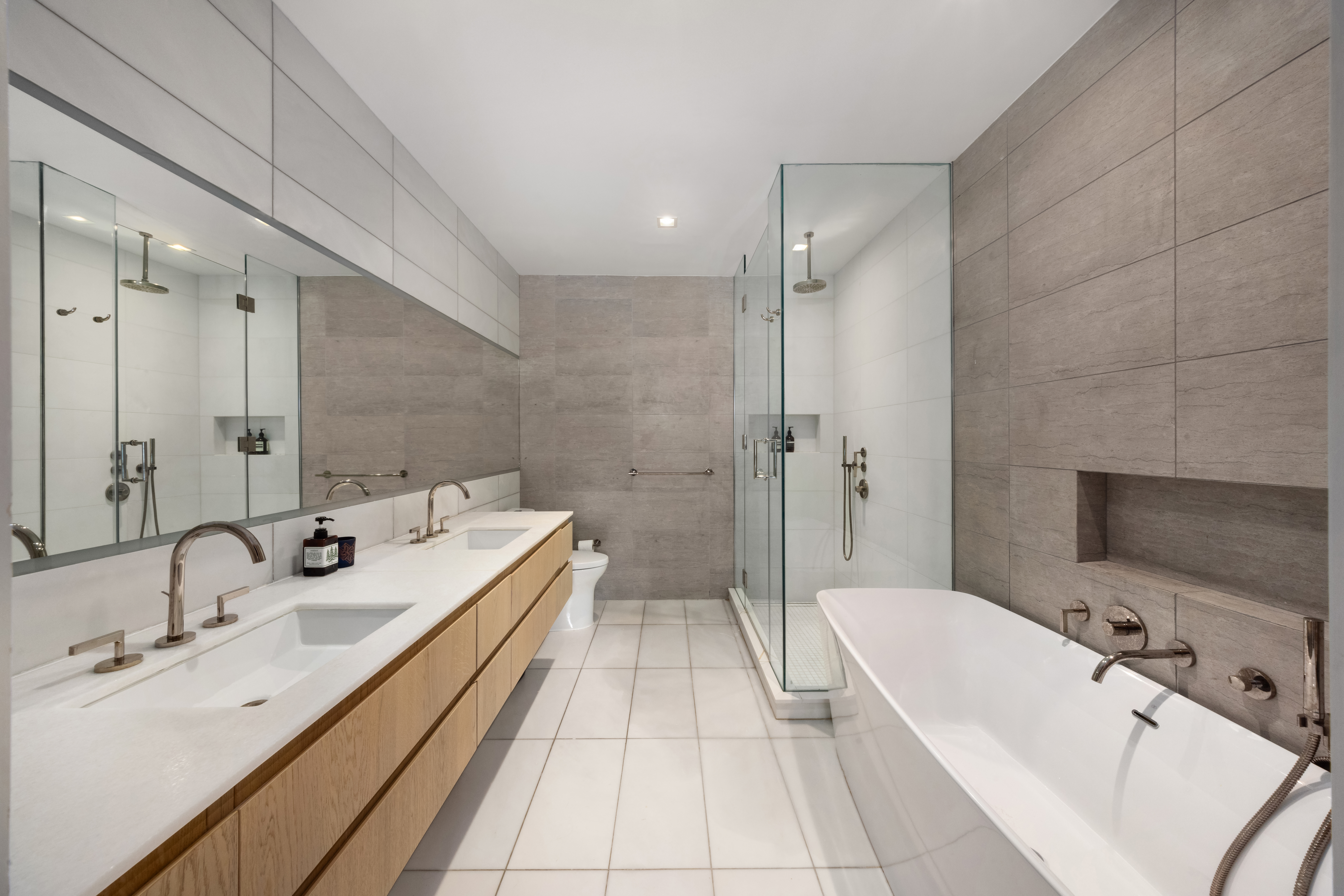 138 North 10th Street, Unit 302 Brooklyn, NY 11249 - Photo 9 of 15 a bathroom with a tub double sink shower and mirror