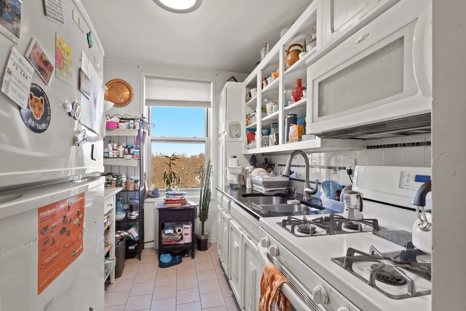 a utility room with lots of clutter and cabinets