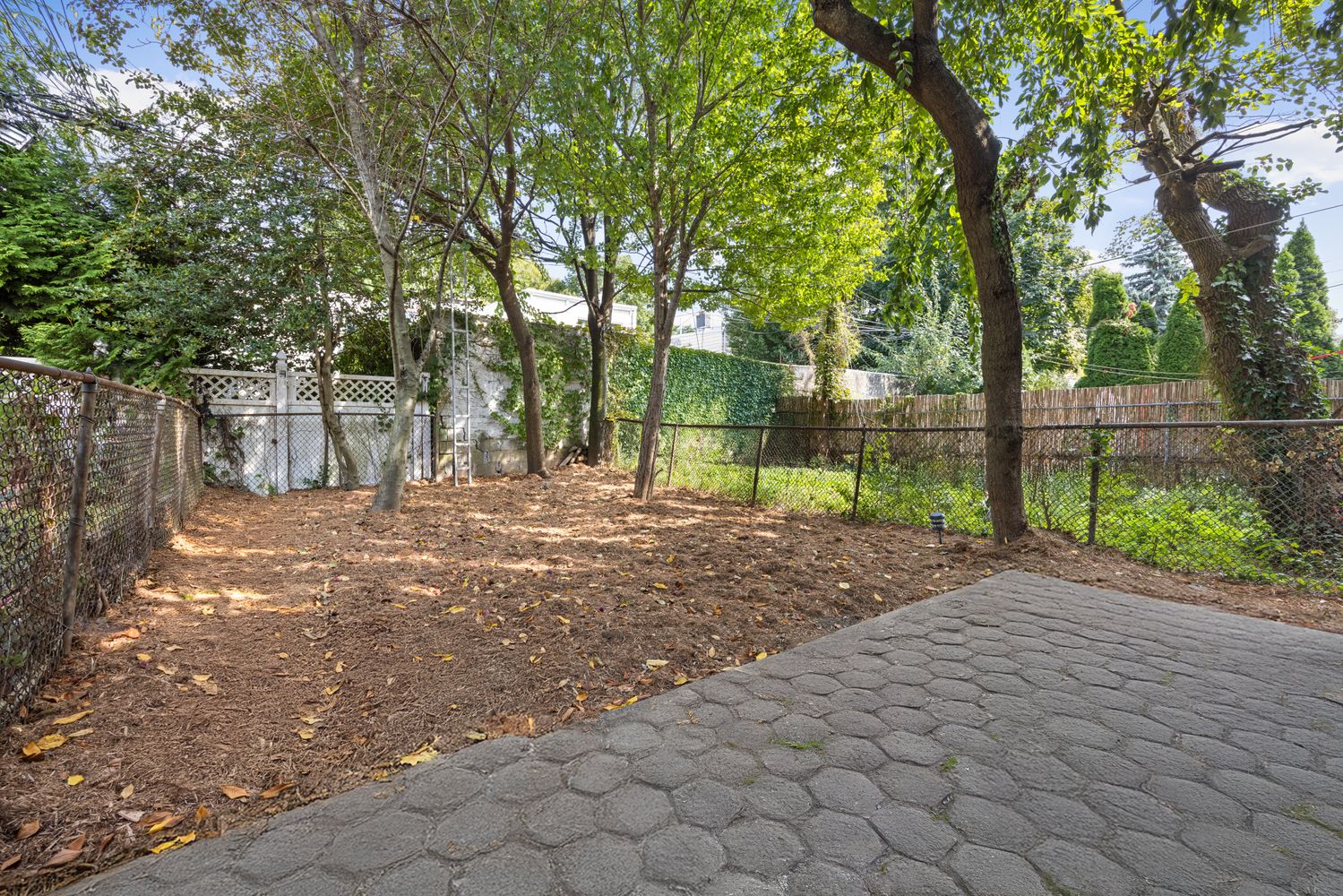 99 East 2nd Street, Unit 1 Brooklyn, NY 11218 - Photo 5 of 7 a view of a backyard with trees
